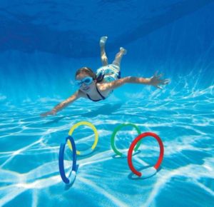 Girl diving for rings in swimming pool